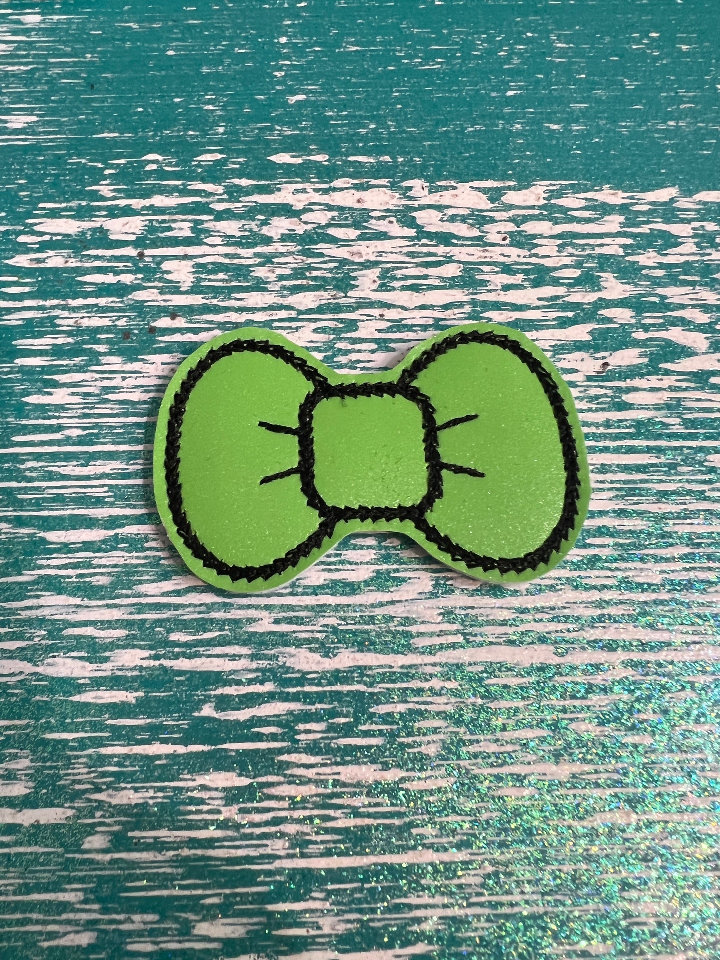 Green bow with black line